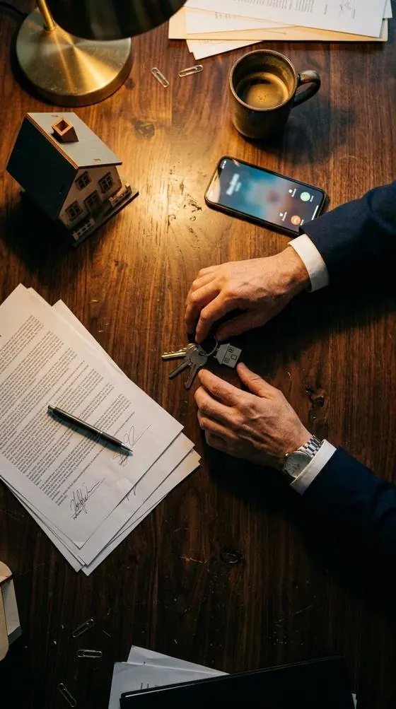 A realtor’s desk with a phone showing an incoming call